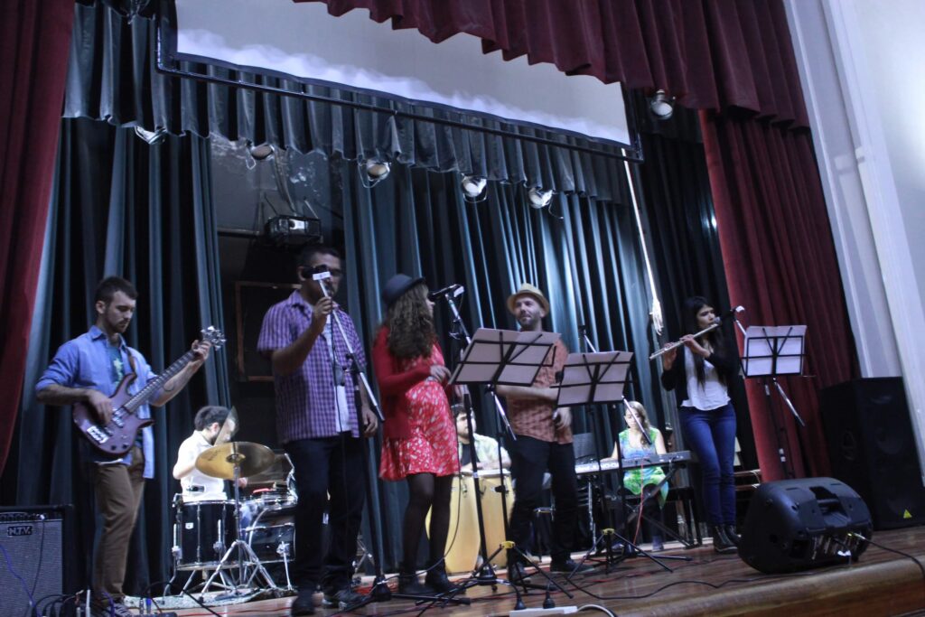 Music band in a theater stage playing cuban music.